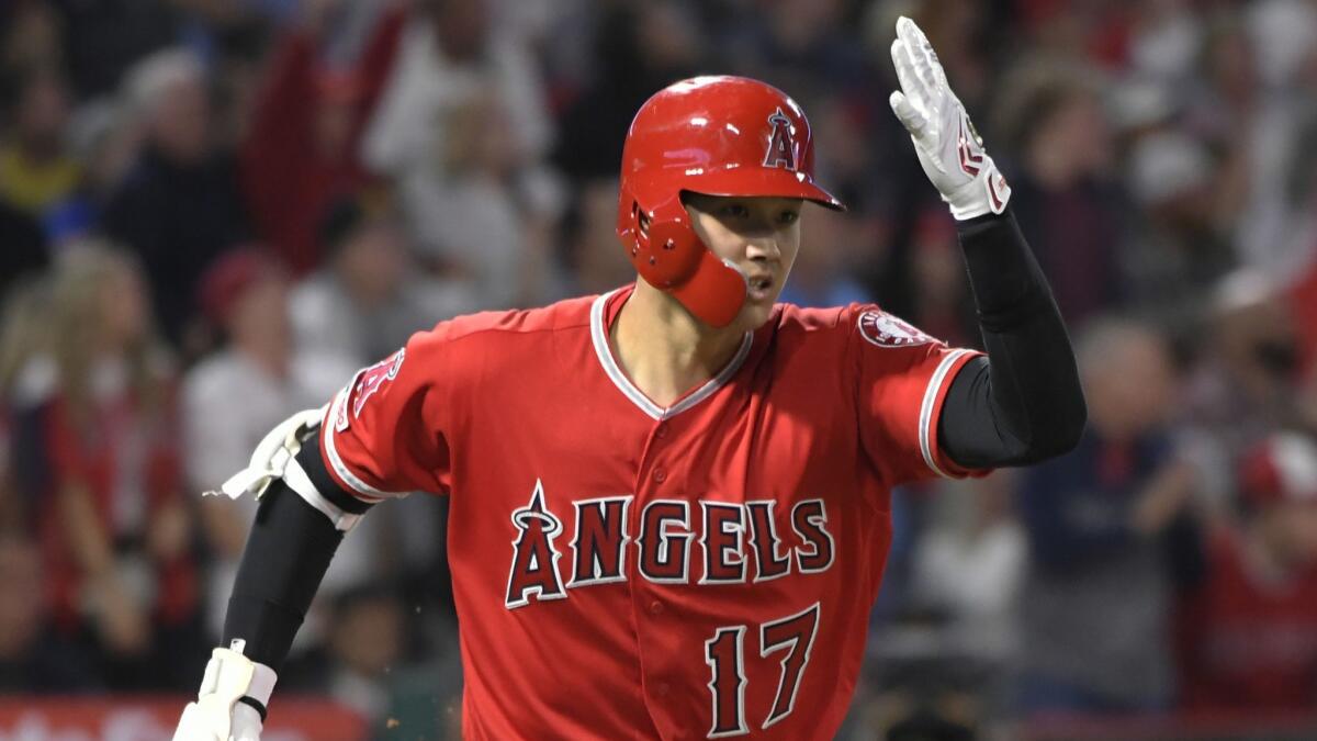 Angels designated hitter Shohei Ohtani gestures after hitting a home run off Mariners pitcher Yusei Kikuchi in the fourth inning Saturday.