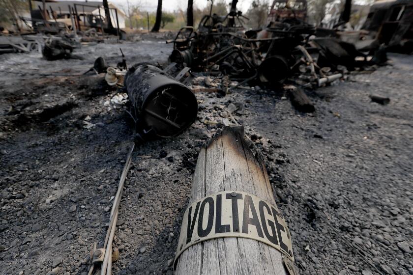 HEALDSBURG, CALIF. - OCT. 28, 2019. A charred utility pole lies amid burned machinery along Chalk Hill Road near Healdsburg on Tuesday, Oct. 29, 2019. (Luis Sinco/Los Angeles Times)