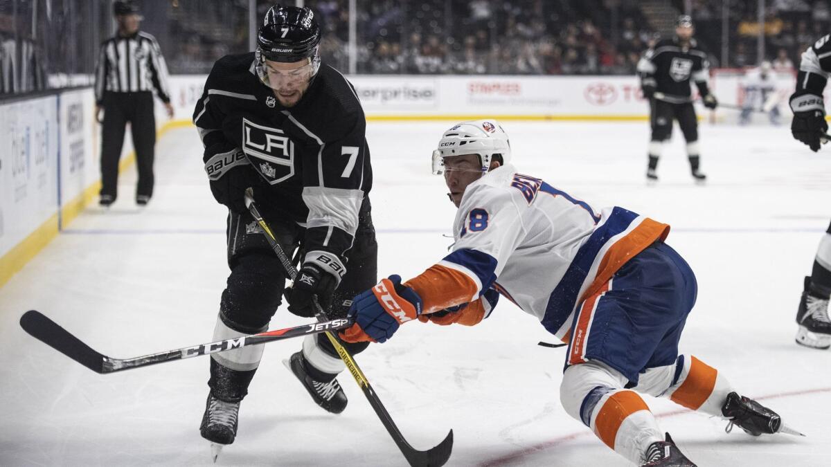 Kings defenseman Oscar Fantenberg, left, and New York Islanders center Anthony Beauvillier battle for the puck in the third periodon Oct. 18, 2018 in Los Angeles.