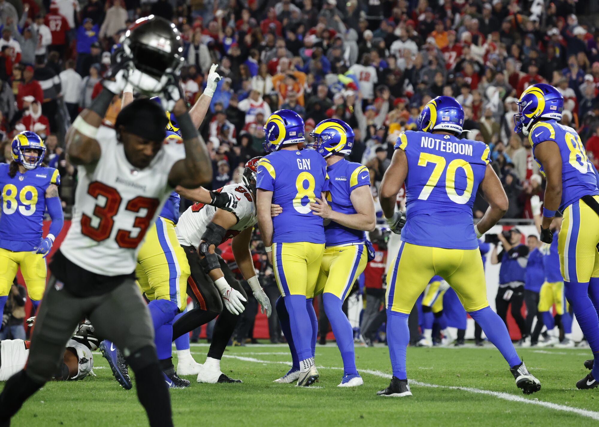 Tampa Bay Buccaneers free safety Jordan Whitehead throws his helmet as the Rams celebrate.
