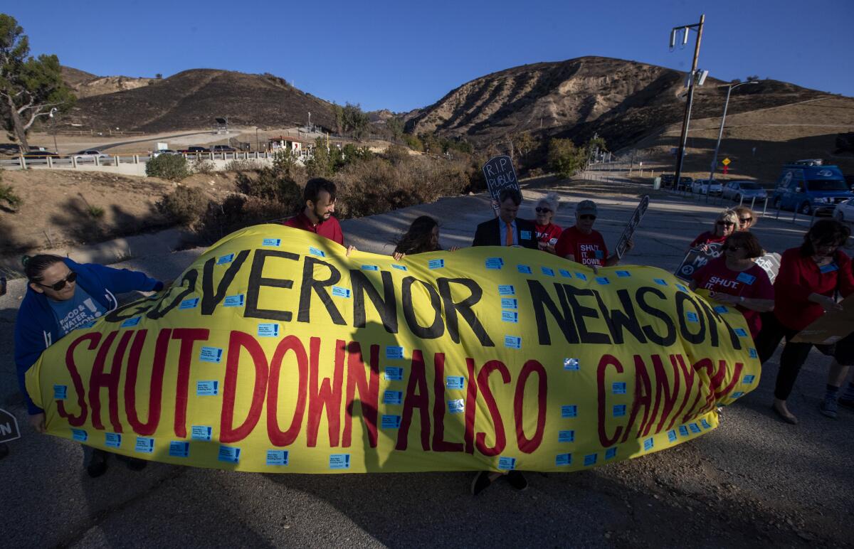 North San Fernando Valley residents hold a banner in windy conditions.