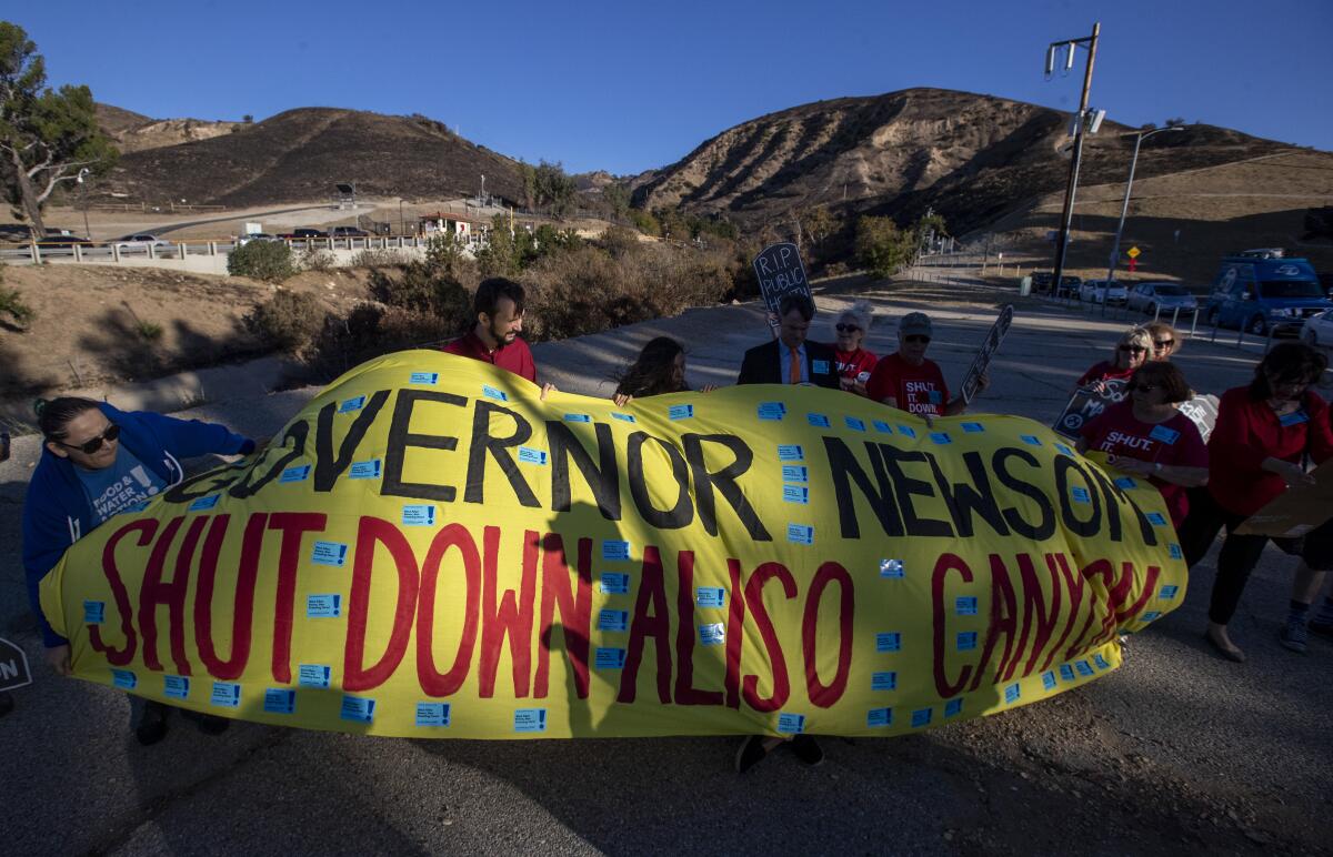 Protesters unfurl a banner in Porter Ranch marking the fourth anniversary of the Aliso Canyon methane blowout in 2019.