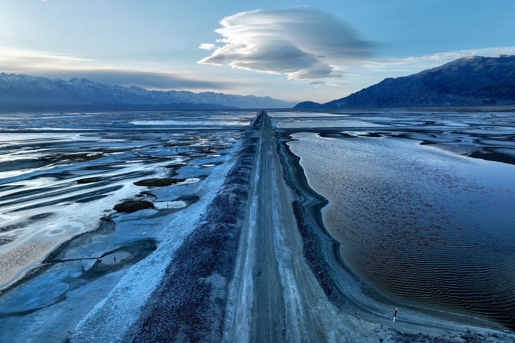 An aerial frame of pools of water in Owens Lake during a 'blue hour' after sunset.