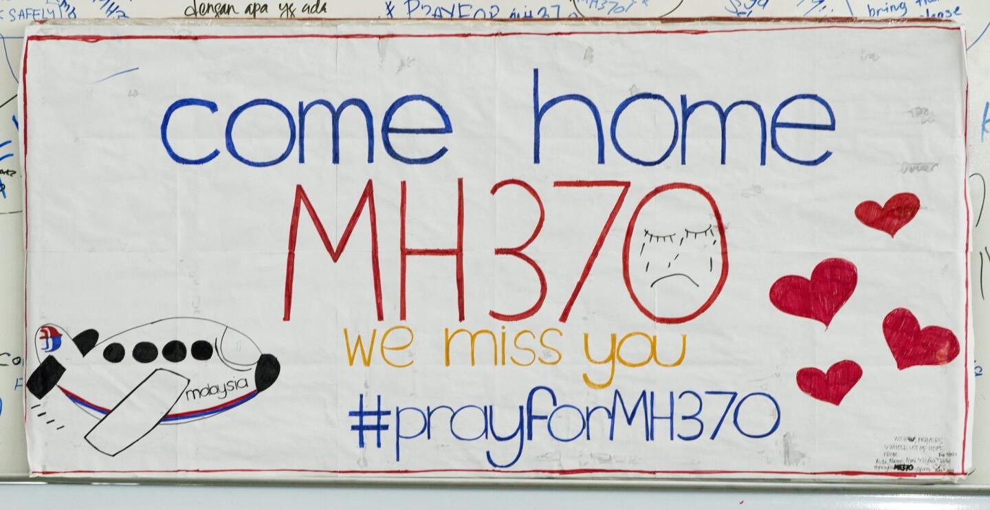 A note by wellwishers for the missing Malaysian Airline plane is written on a cardboard at Kuala Lumpur International Airport, Sepang, Selangor, Malaysia, 12 March 2014.
