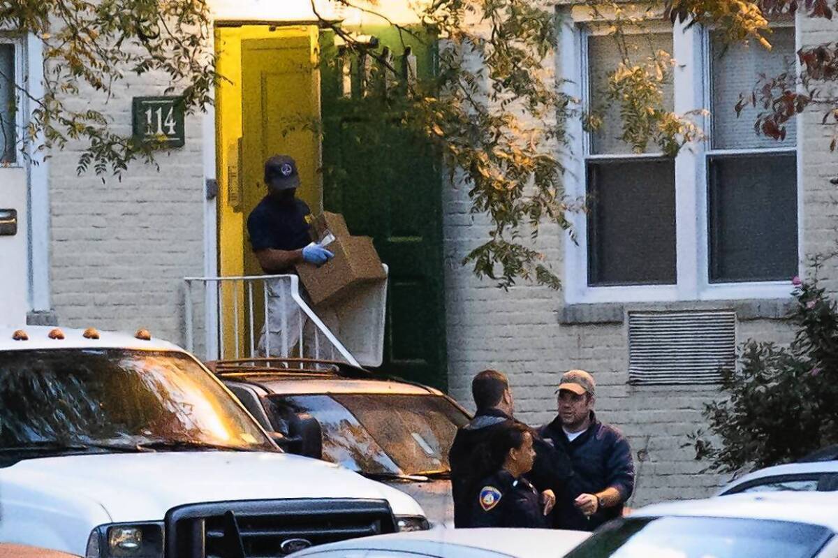 A federal agent takes evidence from an apartment where Miriam Carey lived in Stamford, Conn. She was killed by police after a confrontation with officers and the Secret Service and a car chase in Washington, D.C.