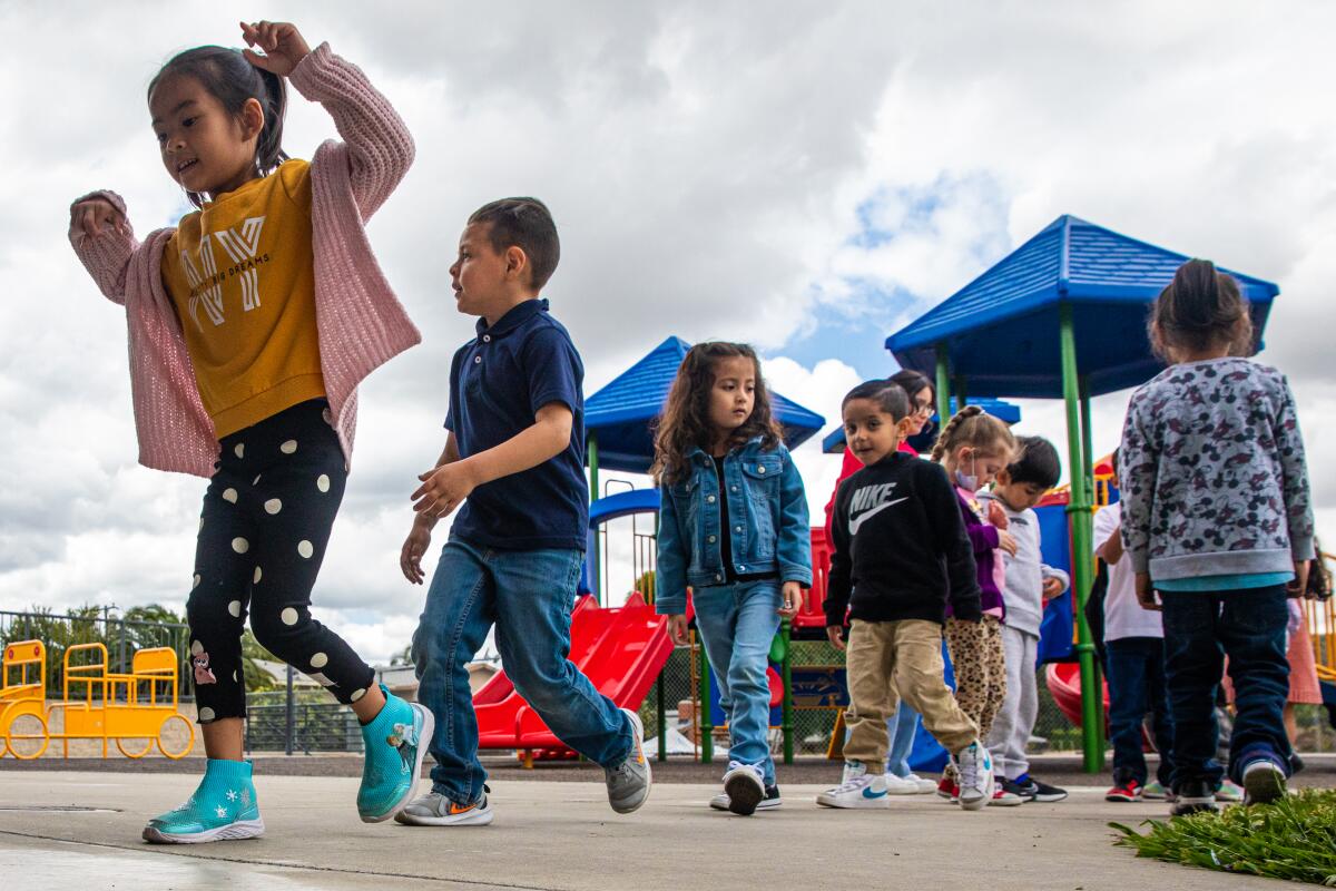 Children line up on a playground.