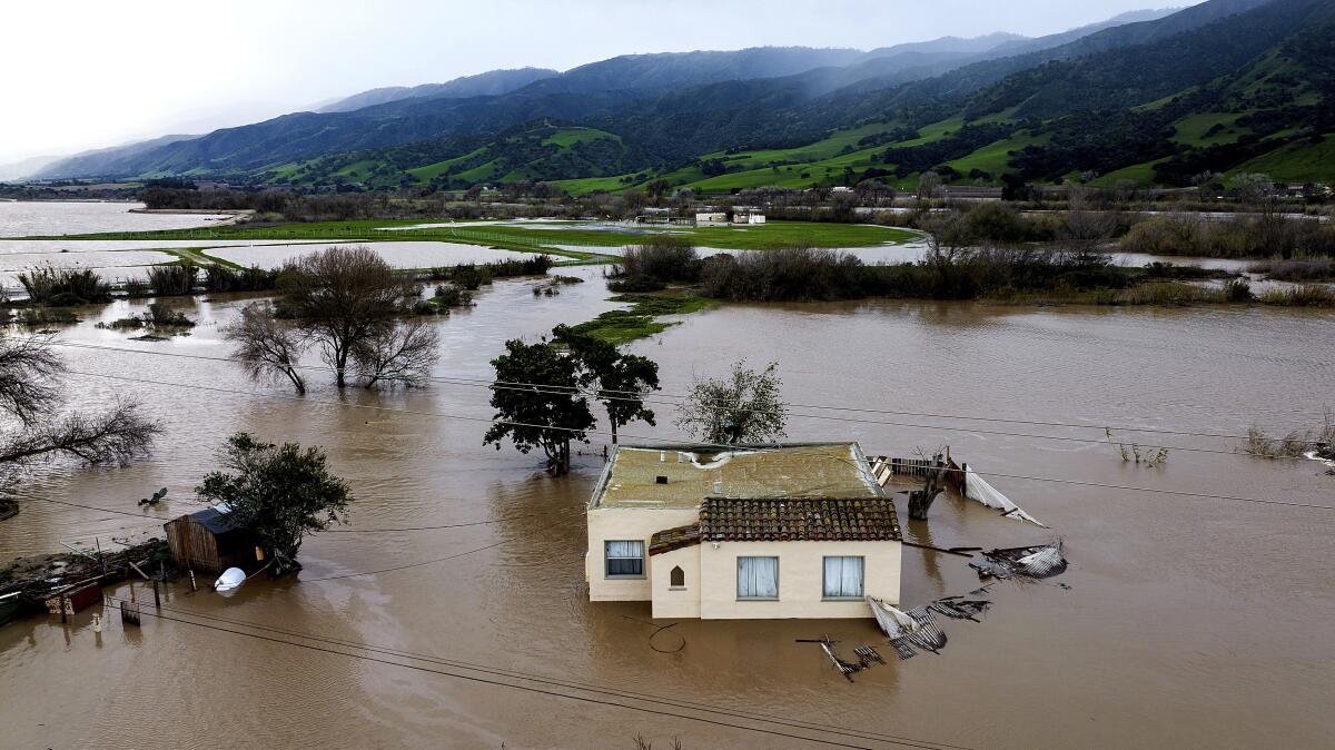 Floodwaters surround a home in the Chualar community of Monterey County, Calif. 