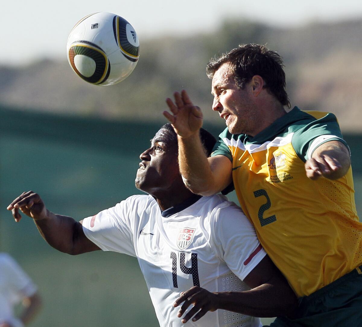 Edson Buddle, left, of the U.S. and Australia's Lucas Neill fight for the ball during a game on June 5, 2010.