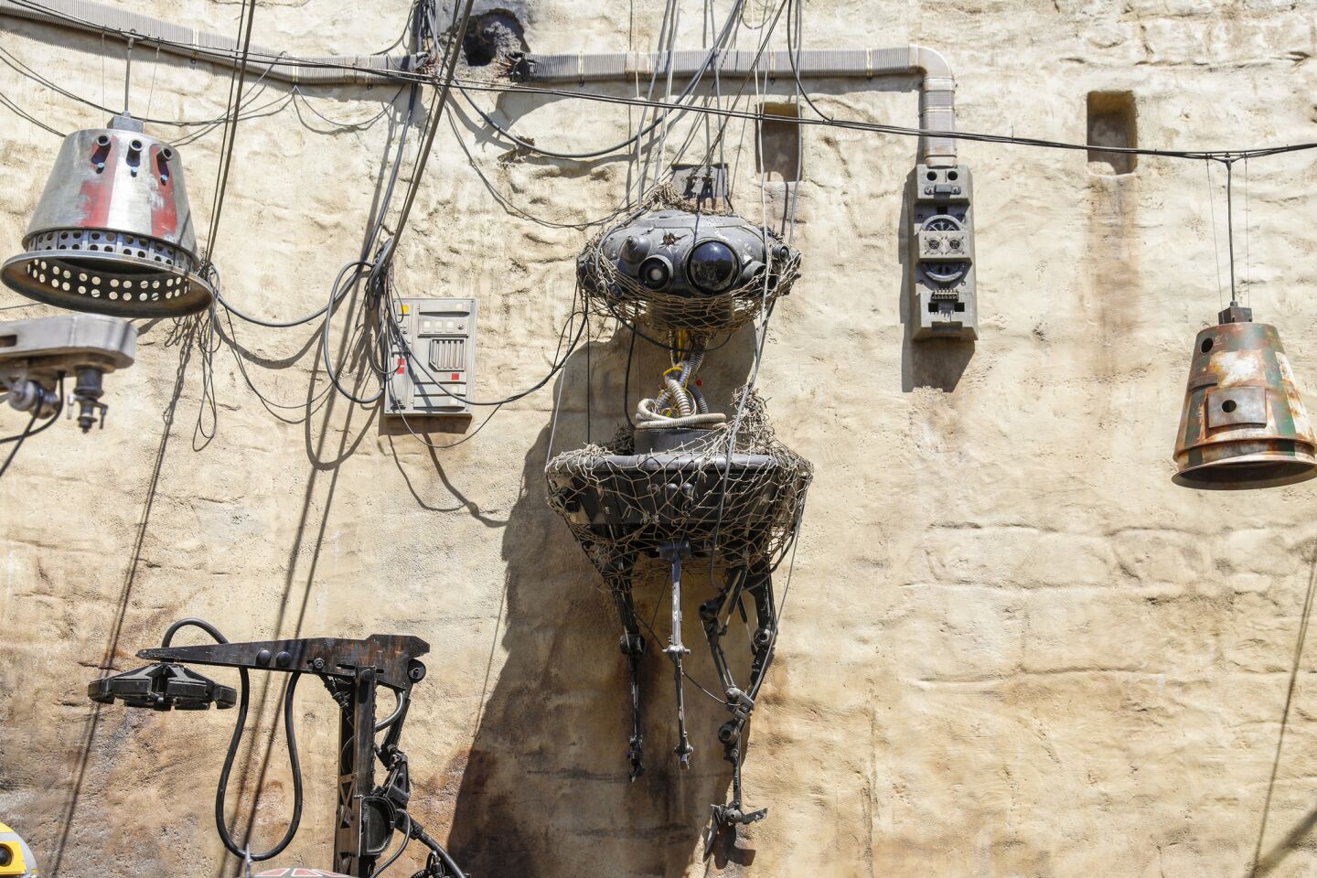What look to be droid parts hang in a section of Star Wars: Galaxy's Edge at Disneyland.