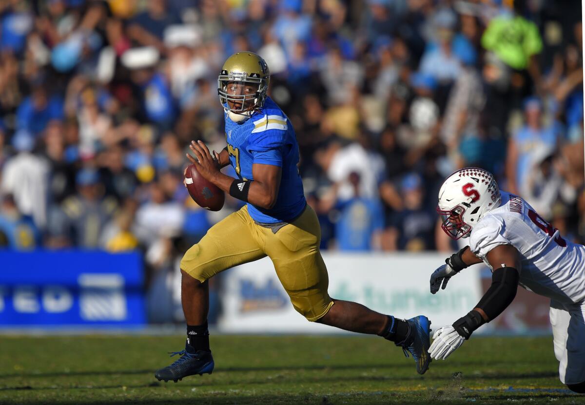 UCLA quarterback Brett Hundley escapes a tackle by Stanford linebacker James Vaughters at the Rose Bowl on Nov. 28, 2014.
