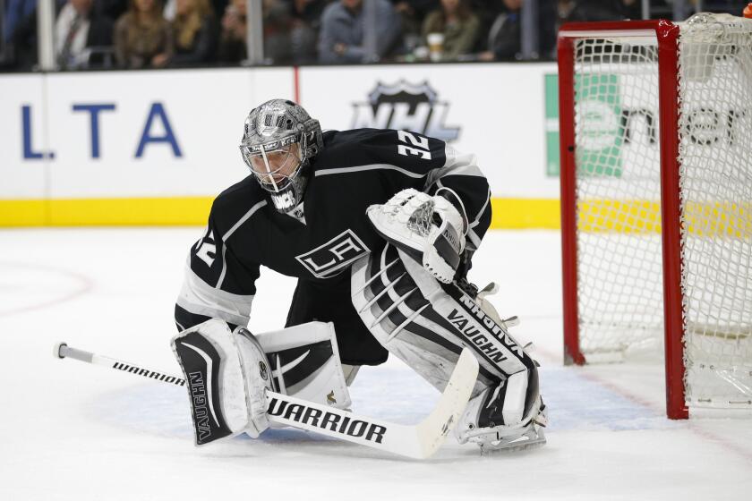 Kings goalie Jonathan Quick goes down to a knee in front of the net during the third period of a game against the Flyers.