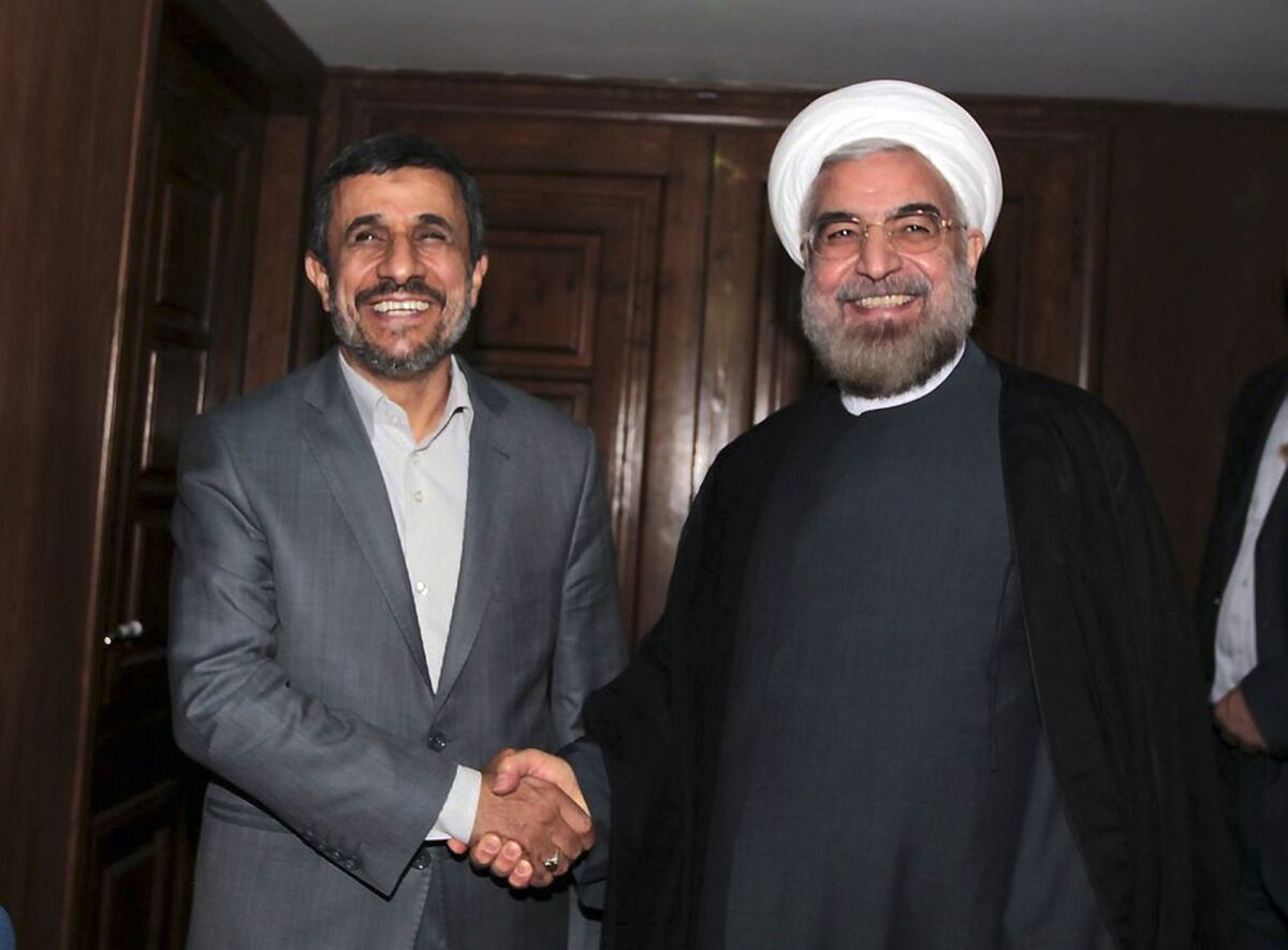 President-elect Hassan Rowhani has vowed for better ties with the world, and aims to reduce the West's sanctions against Iran over the country's disputed nuclear program. Above: Outgoing Iranian President Mahmoud Ahmadinejad, left, shakes hands with Rowhani during a meeting in Tehran, Iran.