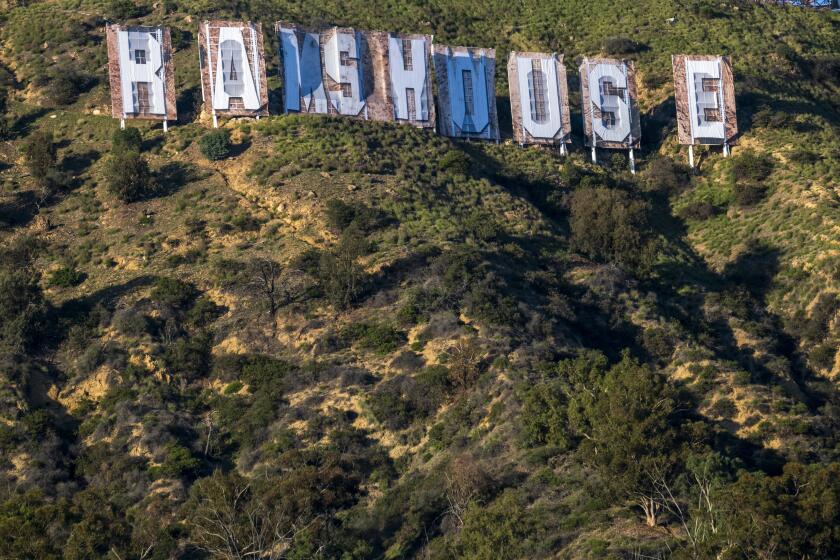 HOLLYWOOD, CA - FEBRUARY 16: Hollywood sign has been transformed to "Rams House," on Wednesday, Feb. 16, 2022 in Hollywood, CA. The Hollywood sign installation is temporarily transformed to celebrate the Rams' Super Bowl LVI victory over the Cincinnati Bengals Sunday, Mayor Eric Garcetti announced. The iconic sign will be altered to read, "Rams House," and will be displayed Monday through Wednesday. (Francine Orr / Los Angeles Times)
