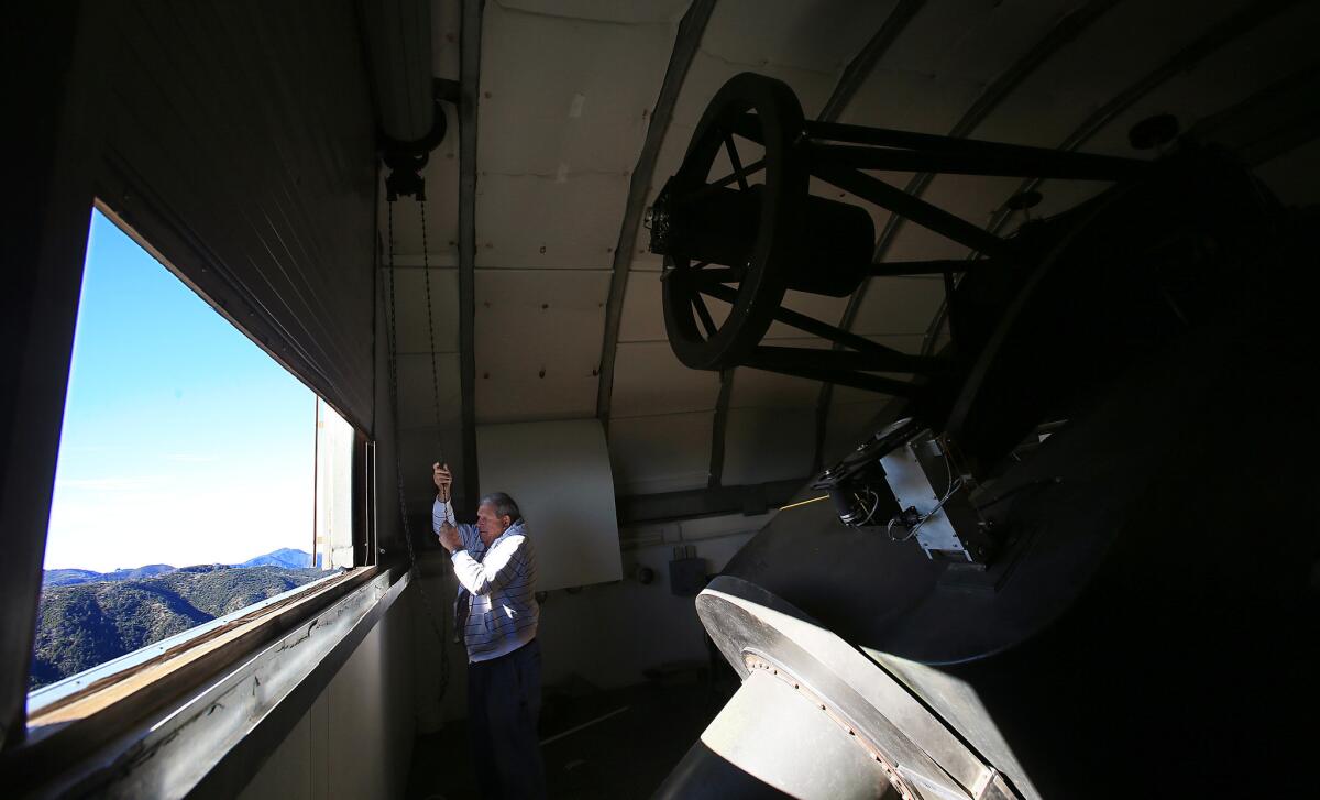 Gordon Jones of the Monterey Institute for Research in Astronomy looks out from telescope tower of the station.