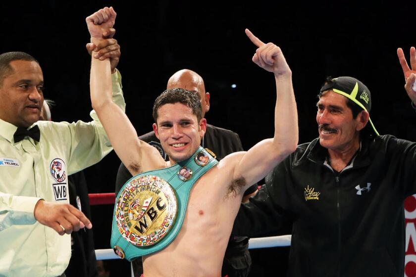 Mexican champion Carlos Cuadras (C) raises his fists in the air after retaining his champion's belt of the WBC super flyweight title boxing match in Sendai in Miyagi prefecture, northern Japan on November 28, 2015. Cuadras defeated Koki Eto of Japan by unanimous decision. AFP PHOTO / JIJI PRESS JAPAN OUT / AFP / JIJI PRESS / JIJI PRESS (Photo credit should read JIJI PRESS/AFP/Getty Images) ** OUTS - ELSENT, FPG, CM - OUTS * NM, PH, VA if sourced by CT, LA or MoD **
