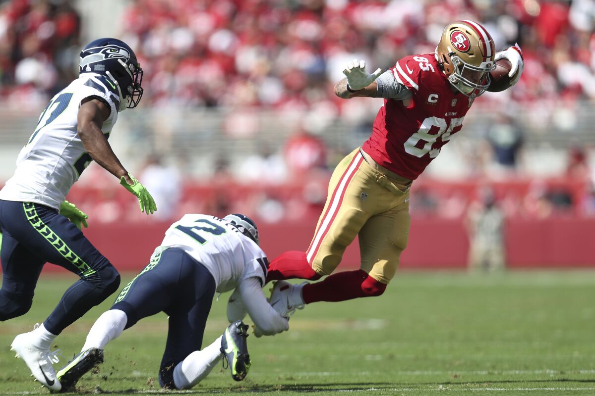 San Francisco 49ers tight end George Kittle (85) runs against Seattle Seahawks cornerback D.J. Reed (2) and defensive back Marquise Blair during the first half of an NFL football game in Santa Clara, Calif., Sunday, Oct. 3, 2021. (AP Photo/Jed Jacobsohn)