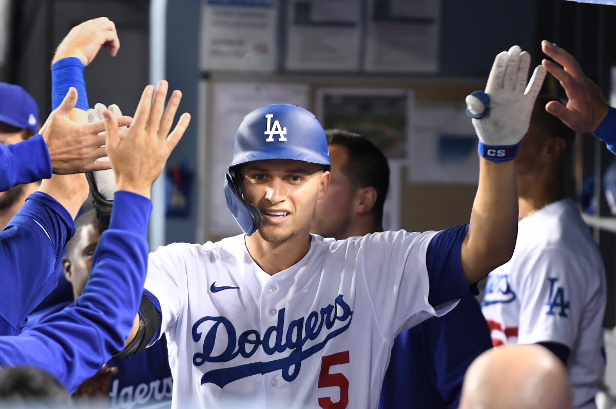 Corey Seager is congratulated by Dodgers teammates after hitting a home run.