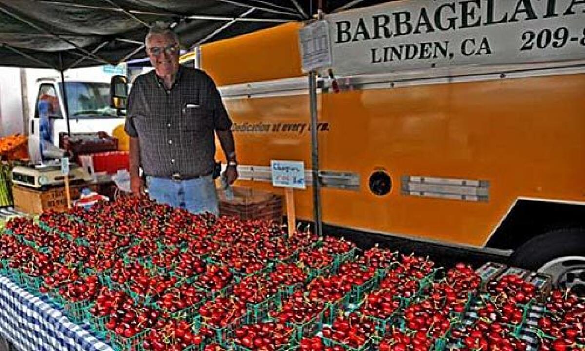 J.P. Barbagelata of Linden sells Early Burlat cherries at the Santa Monica farmers market.