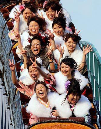 Kimono-clad participants, who turn 20 this year, enjoy a roller coaster ride after a ceremony at Tokyo's Toshimaen amusement park to mark the Japanese national holiday Coming of Age Day.