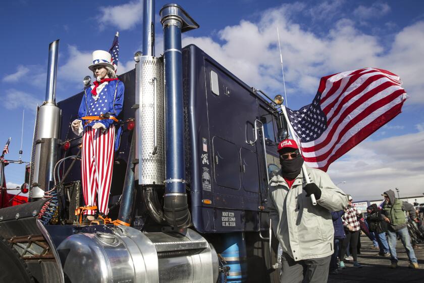 Adelanto, CA - February 23: California truckers against COVID-19 mandate form a People's Convoy to Washington D.C. at a rally held at Adelanto Stadium on Wednesday, Feb. 23, 2022 in Adelanto, CA. (Irfan Khan / Los Angeles Times)