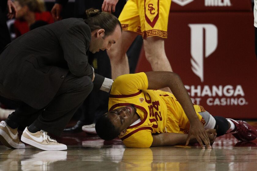 LOS ANGELES, CA - FEBRUARY 2, 2023: USC Trojans forward Joshua Morgan (24) is tended to after being injured.