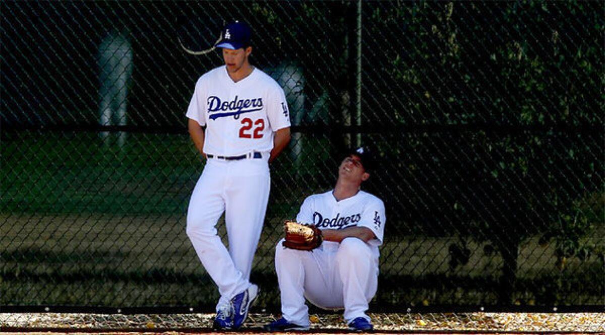 Dodgers starting pitchers Clayton Kershaw, left, and Chad Billingsley seek refuge from the Arizona sun.