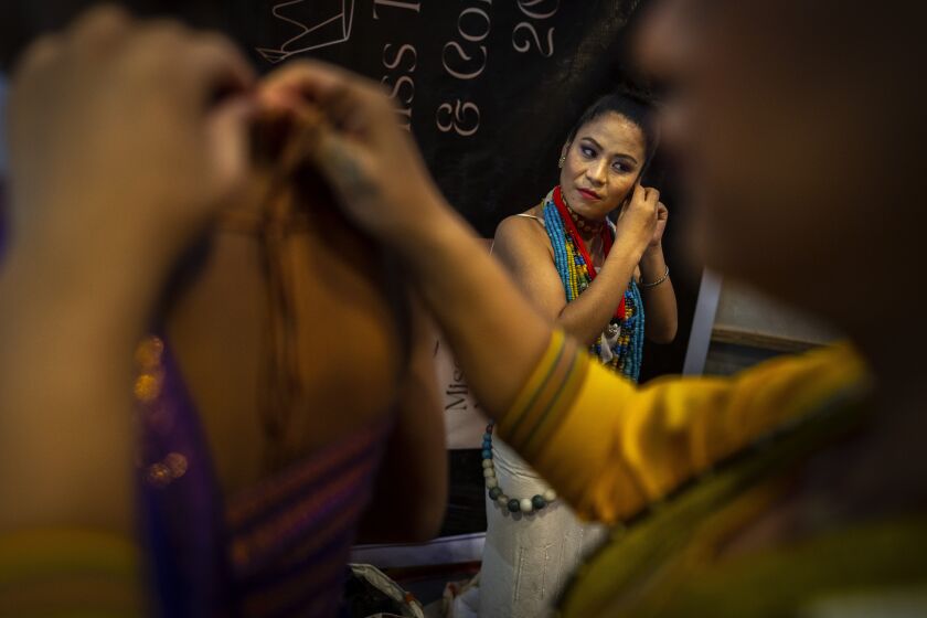 Participants get ready for the Miss Trans Northeast 22, beauty pageant in Guwahati, India, Wednesday, Nov. 30, 2022. In a celebration of gender diversity and creative expression, a beauty pageant in eastern Indian state of Assam brought dozens of transgender models on stage in Guwahati. Sexual minorities across India have gained a degree of acceptance especially in big cities and transgender people were given equal rights as a third gender in 2014. But prejudice against them persists and the community continues to face discrimination and rejection by their families. (AP Photo/Anupam Nath)