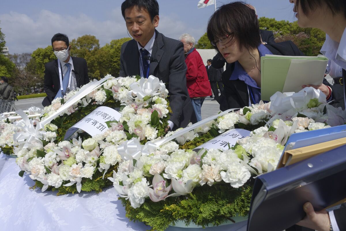 Officials place wreaths as they prepare for a visit by the Group of Seven foreign ministers at the Hiroshima Peace Memorial Park in Hiroshima.
