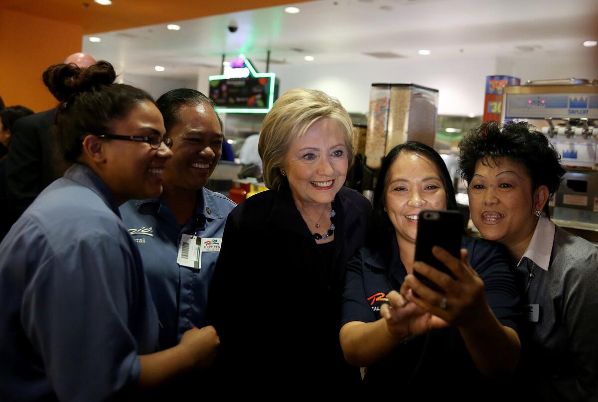 Hillary Clinton, center, takes a selfie with service workers at Rio All-Suite Las Vegas Hotel and Casino on Thursday.