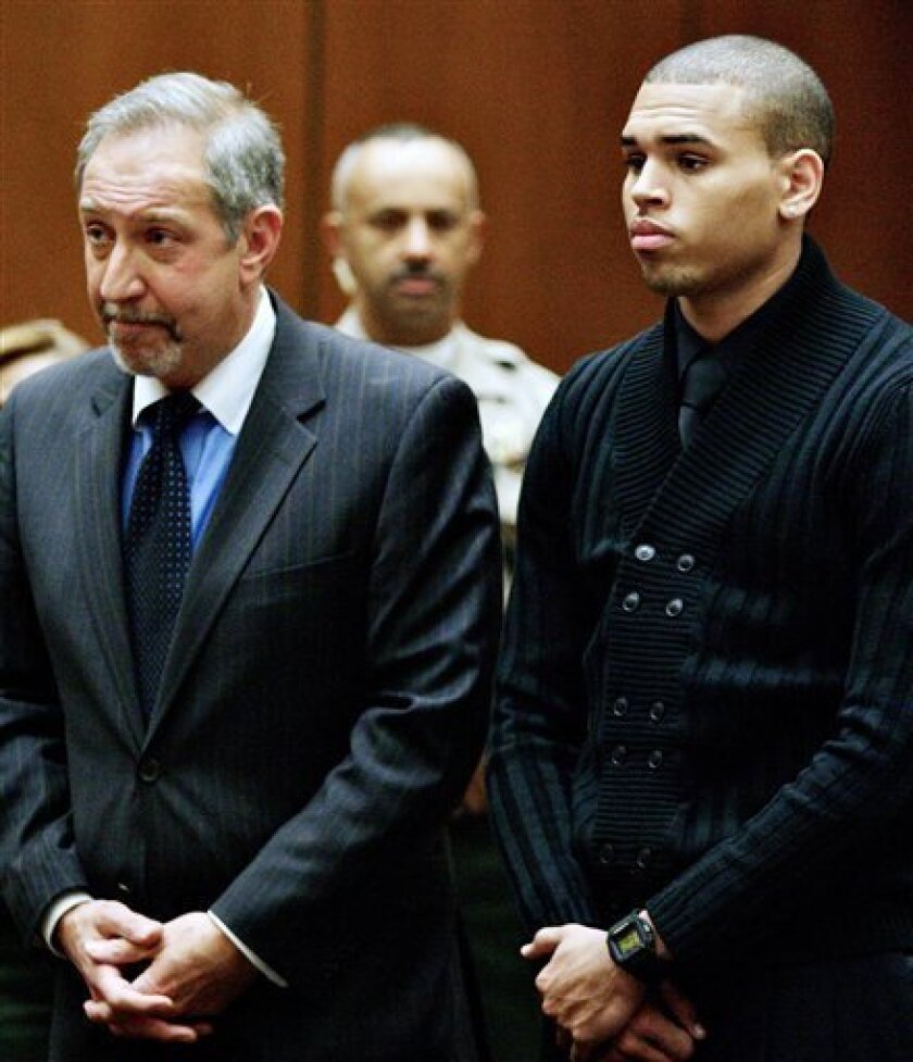 Chris Brown, right, and his attorney Mark Geragos, left, appear during his arraignment on two felony charges, at the Los Angeles County Criminal Courts in downtown Los Angeles on Monday, April 6, 2009. Brown, pleaded not guilty to threatening and assaulting his girlfriend, fellow music superstar Rihanna. (AP Photo/Damian Dovarganes, Pool)
