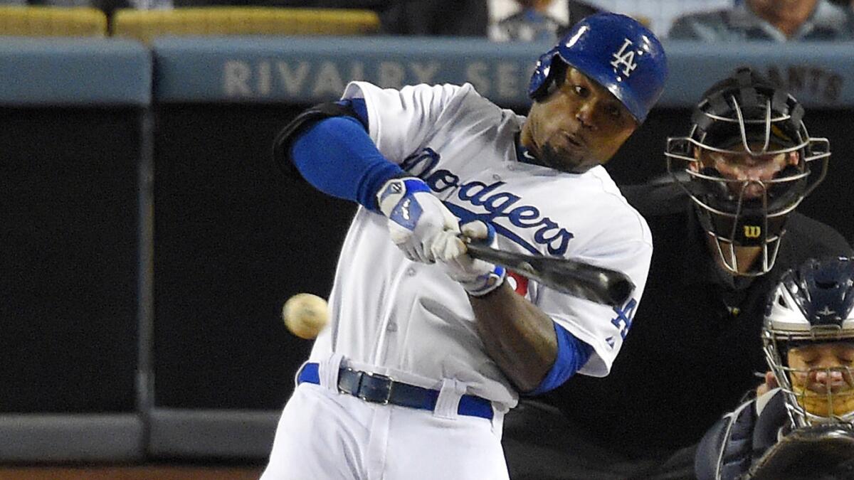Dodgers left fielder Carl Crawford hits a run-scoring double in the eighth inning of a 4-0 victory over the San Diego Padres on Wednesday.