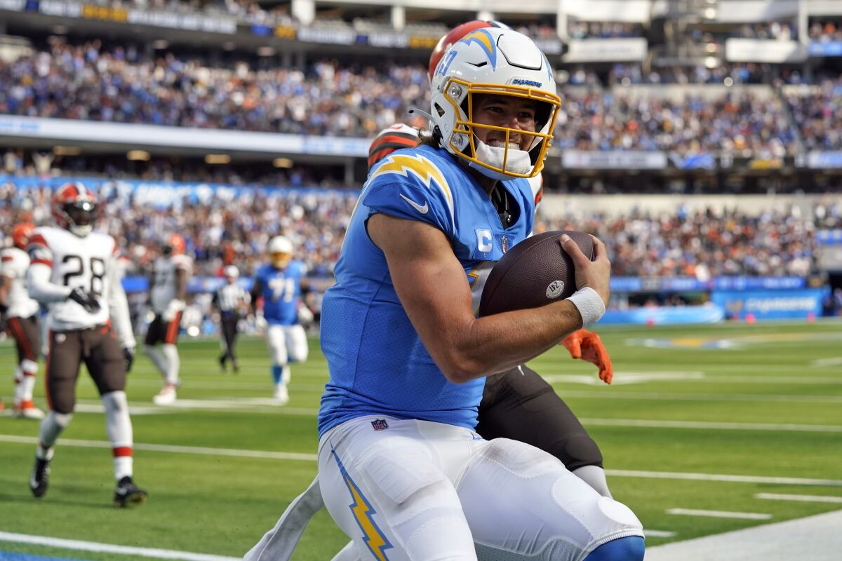 Los Angeles Chargers quarterback Justin Herbert (10) scores a touchdown during the second half of an NFL football game against the Cleveland Browns Sunday, Oct. 10, 2021, in Inglewood, Calif. (AP Photo/Gregory Bull)