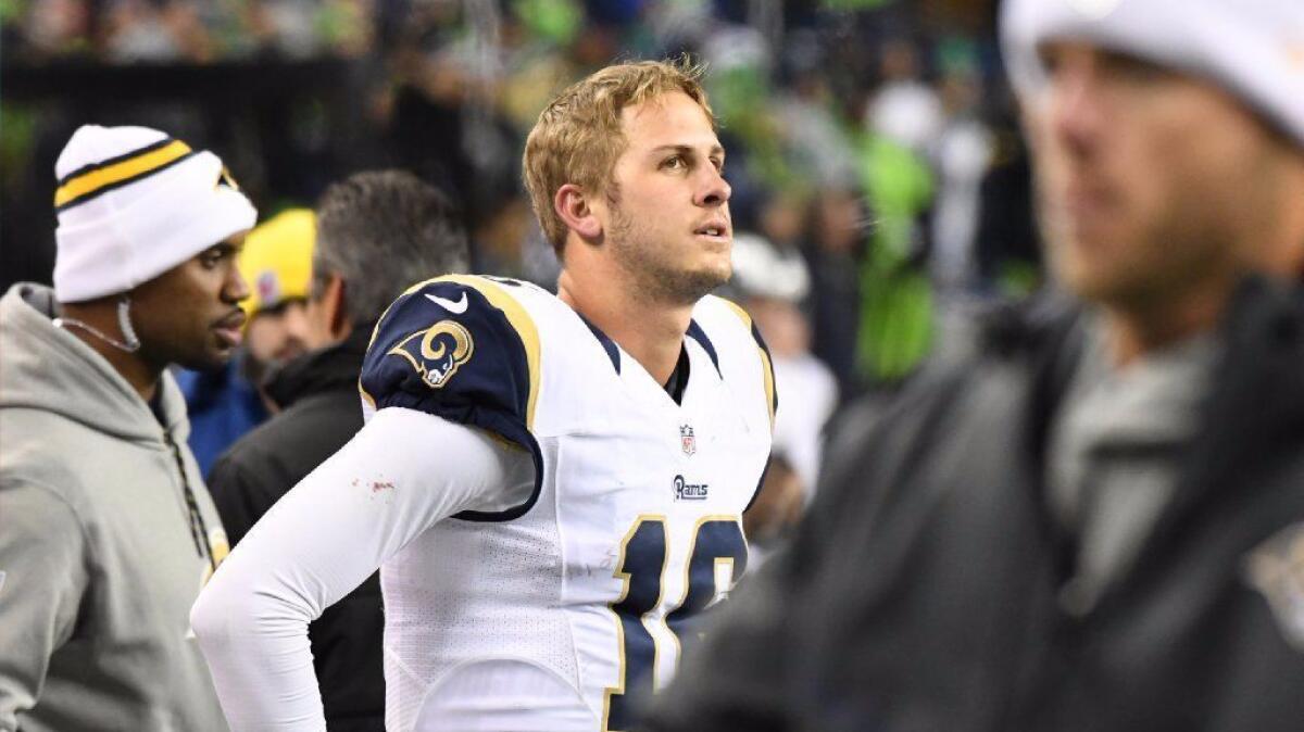 Rams rookie quarterback Jared Goff stands on the sideline without his helmet after absorbing a big hit from Seattle cornerback Richard Sherman during a game on Dec. 15.