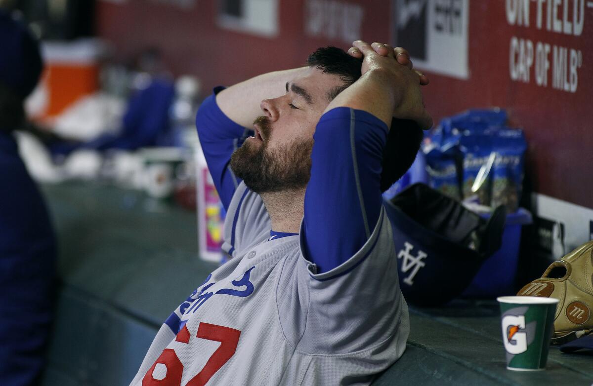 Dodgers pitcher Louis Coleman reacts in the dugout after giving up a game-tying, two-run home run to Diamondbacks shortstop Chris Owings and being removed from the game during the eighth inning.