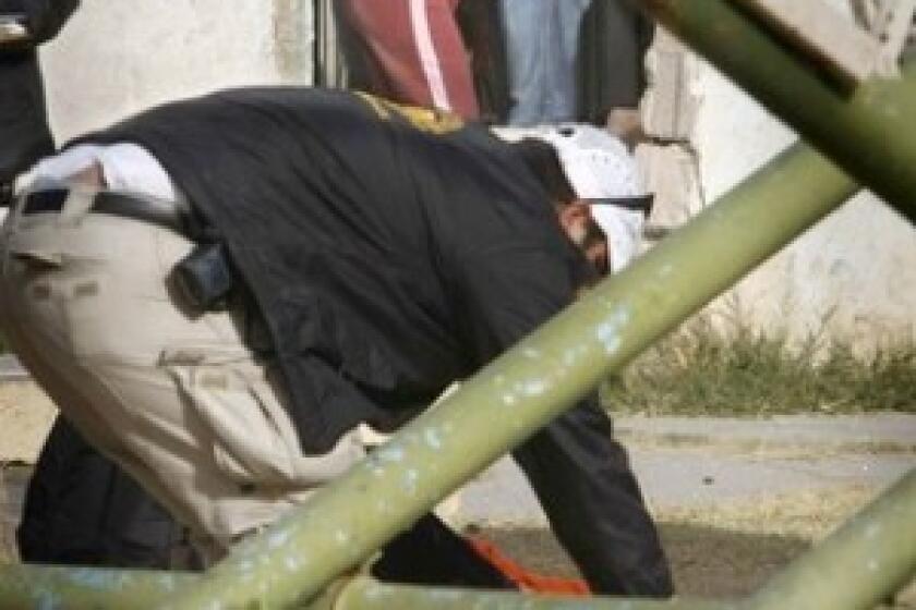 A woman collapses in a relatives arms in Ciudad Juarez, Mexico, after gunmen killed her son and injured the boys father. More than 5,000 people have been slain in drug violence in Mexico this year.