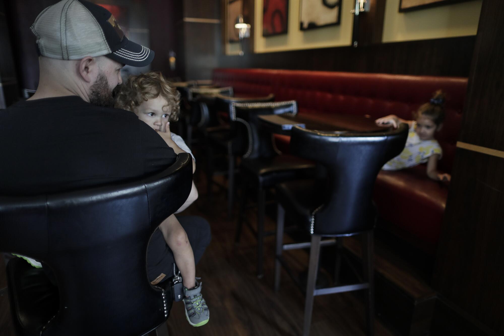  Josh Rathbun with his children Noah, left, and Charlotte at the Ambassador Hotel.