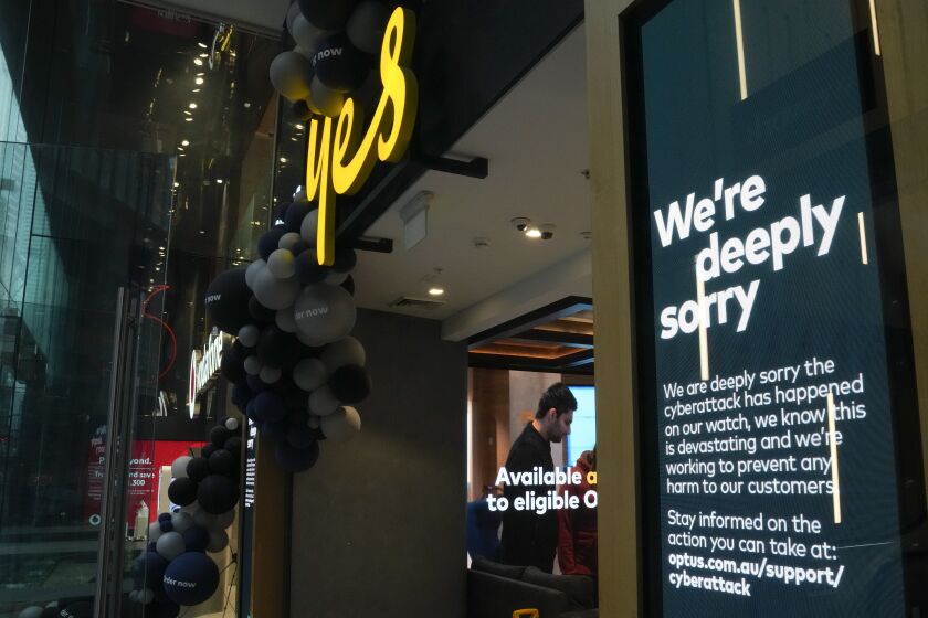 Electronic signage at an Optus telecommunications retail store is seen at the central business district of Sydney, Australia, Wednesday, Oct. 5, 2022. The government has announced changes to telecommunications law, Thursday, Oct. 6 to protect customers of Australia's second-largest wireless carrier, Optus, whose personal details were stolen in a major cyberattack. (AP Photo/Mark Baker)