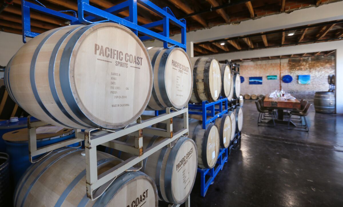 Wooden barrels line the path to the Barrel Room at Pacific Coast Spirits, which opened in 2020 in Oceanside.