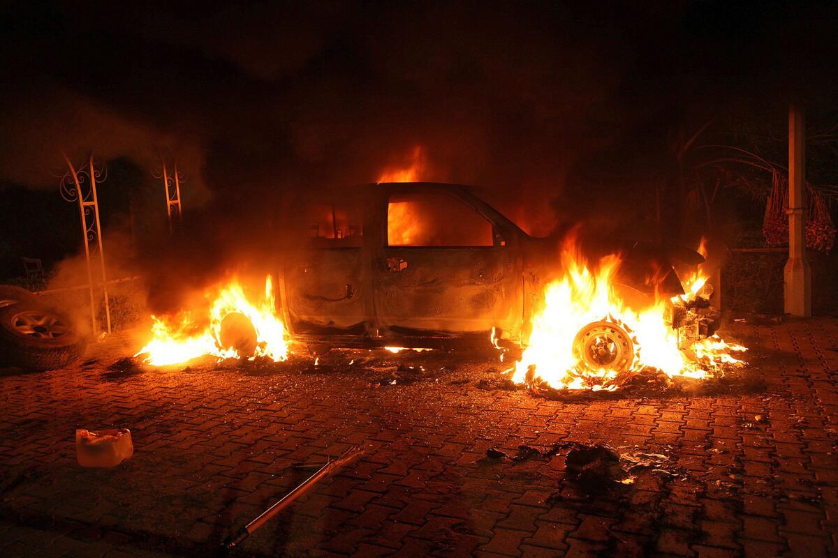 A vehicle is engulfed in flames inside the U.S. diplomatic compound in Benghazi late on Sept. 11, 2012.