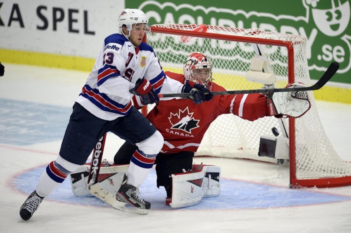 Canada's goaltender, Zach Fucale, reaches for the puck as the United States' Stefan Matteau tries for the tip-in during the second period of Canada's 3-2 victory Tuesday.