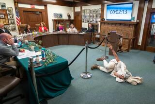 OJAI, CA - Feb. 13, 2024: Cyrus Mayer does a die-in during an Ojai city council meeting as activists urged the city to call for a ceasefire in the IsraeliDPalestinian conflict. (Michael Owen Baker / For The Times)