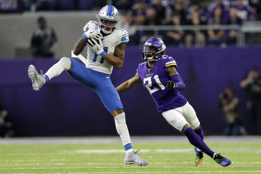 File-This Dec. 8, 2019, file photo shows Detroit Lions wide receiver Marvin Jones catching a pass ahead of Minnesota Vikings cornerback Mike Hughes, right, during the first half of an NFL football game, in Minneapolis. The Vikings have declined the fifth-year contract option for Hughes. The 2018 first-round pick has missed more than half of the games to injuries since he was drafted. Neck trouble that first occurred in 2019 continued last season and limited him to four games. (AP Photo/Andy Clayton-King, File)