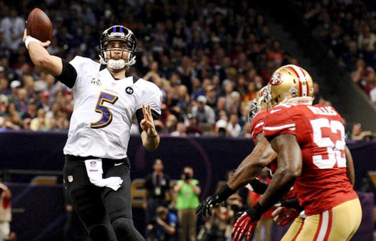 Ravens quarterback Joe Flacco passes under pressure from 49ers linebacker Patrick Willis in the first quarter of the Super Bowl.