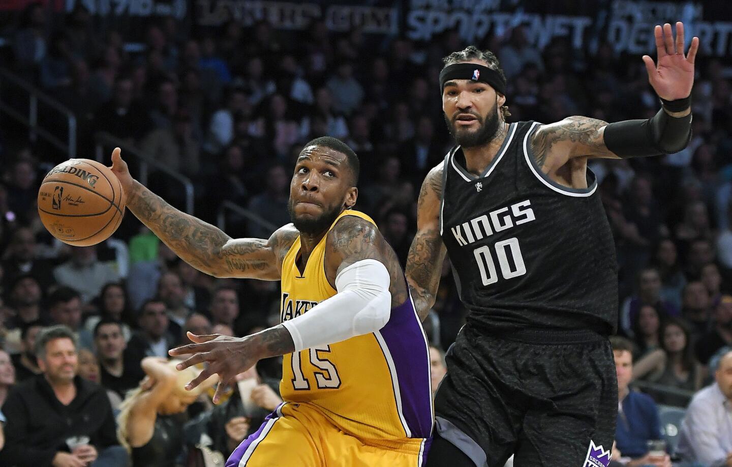 Lakers forward Thomas Robinson drives toward the basket against Kings center Willie Cauley-Stein during the first half.