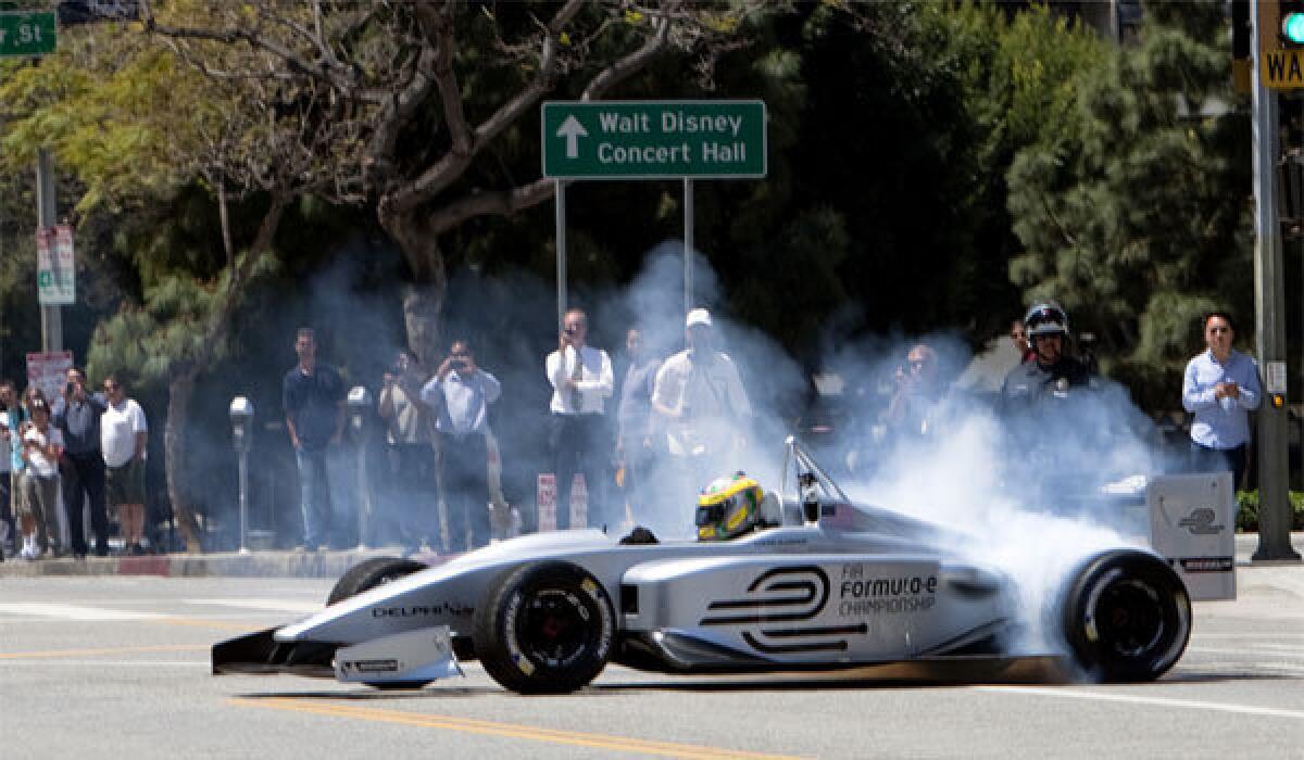 Driver Lucas Di Grassi spins his wheels making doughnut turns while demonstrating the new Formula E electric race car prototype in downtown Los Angeles in April.