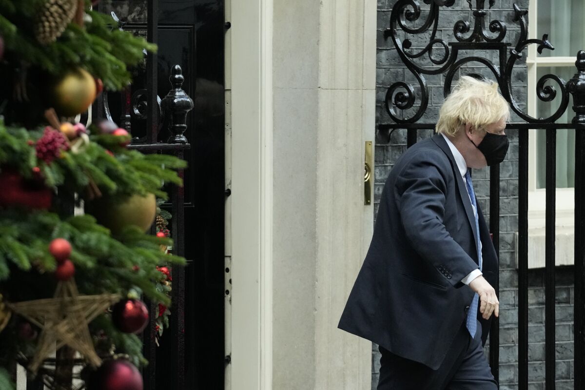 British Prime Minister Boris Johnson walks past a Christmas tree whilst leaving 10 Downing Street to attend the weekly Prime Minister's Questions at the Houses of Parliament, in London, Wednesday, Dec. 1, 2021. (AP Photo/Matt Dunham)