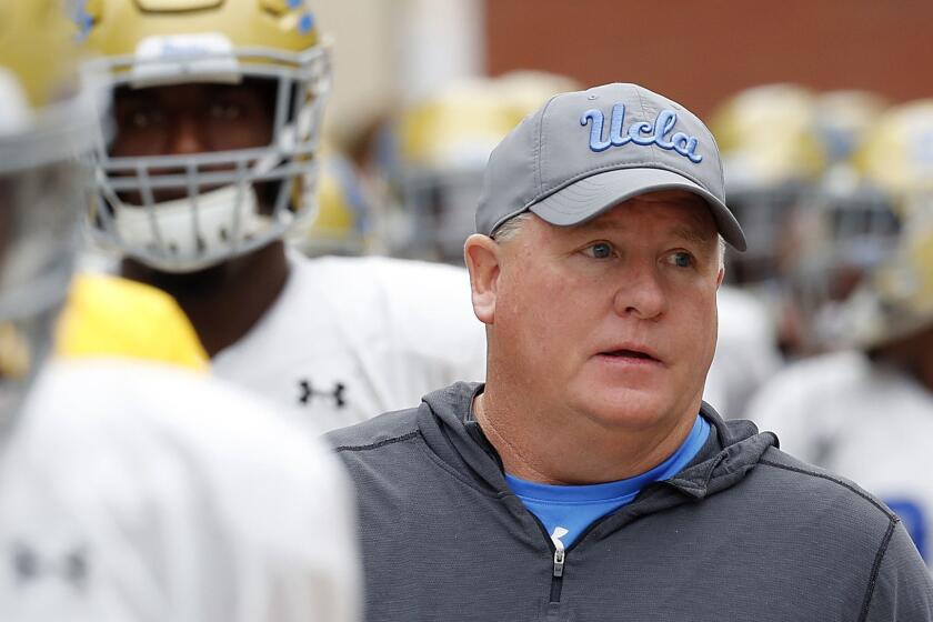 LOS ANGELES, CALIF. - APRIL 20, 2019. UCLA head coach Chip Kelly walks with his team to the annual spring intrasquad football game at Drake Stadium in Westwood on Saturday, April 20, 2019. (Luis Sinco/Los Angeles Times)