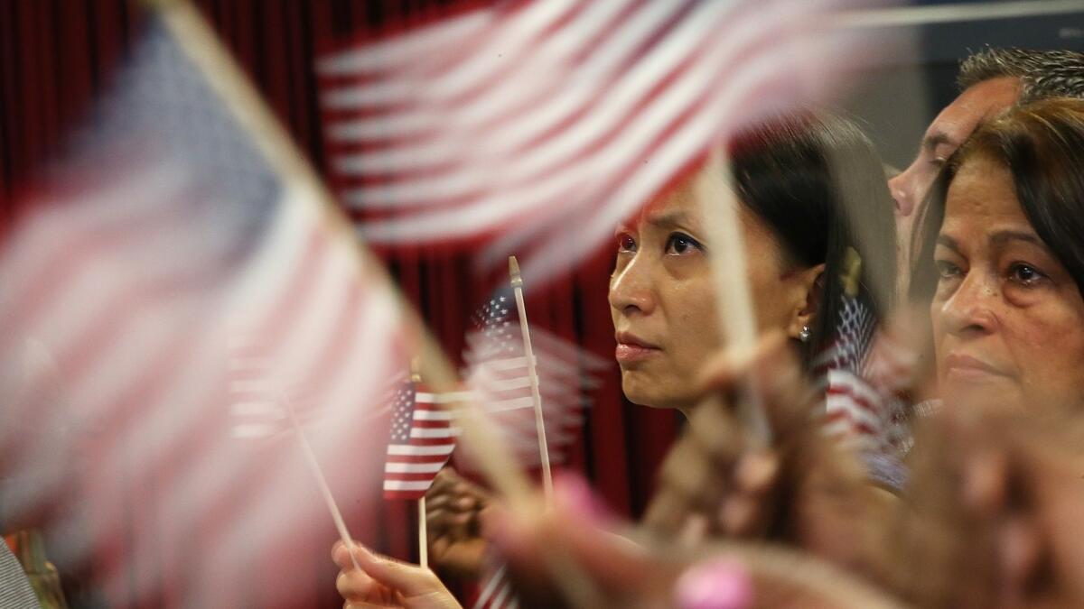 New U.S. citizens participate in a naturalization ceremony in New York on Aug. 23, 2013.