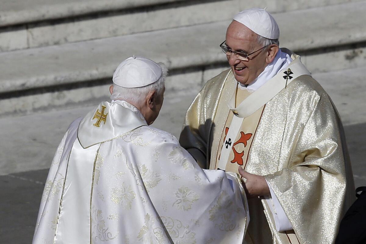 FILE - Pope Emeritus Benedict XVI, left, greets Pope Francis prior to the start of the beatification ceremony of Pope Paul VI and a mass for the closing of a two-week synod on family issues, in St. Peter's Square at the Vatican, Sunday, Oct. 19, 2014. Pope Francis has said that if and when he ever retires, he wouldn’t live in the Vatican or return to his native Argentina but would like to find a church in Rome where he could continue hearing confessions. “I’m the bishop of Rome, in this case the emeritus Bishop of Rome,” Francis said in an interview broadcast Tuesday, July 12, 2022 with Spanish-language broadcaster Univision. (AP Photo/Gregorio Borgia, File)