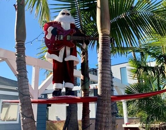 A surf rockin' Santa is spotted along Nautilus Street as he prepares for another sunny La Jolla Christmas.